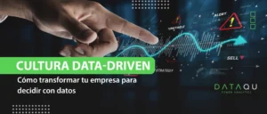 Mano interactuando con gráficos de datos digitales que representan una cultura data-driven en empresas.